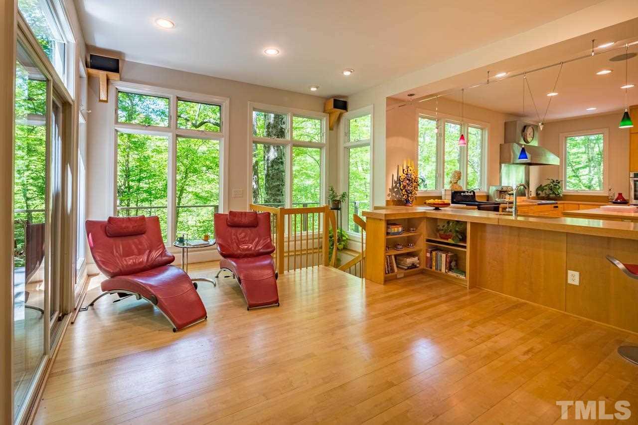 5415 Taproot Lane Durham, NC 27705 - Photo 9 of 30 a living room with furniture stove and large windows