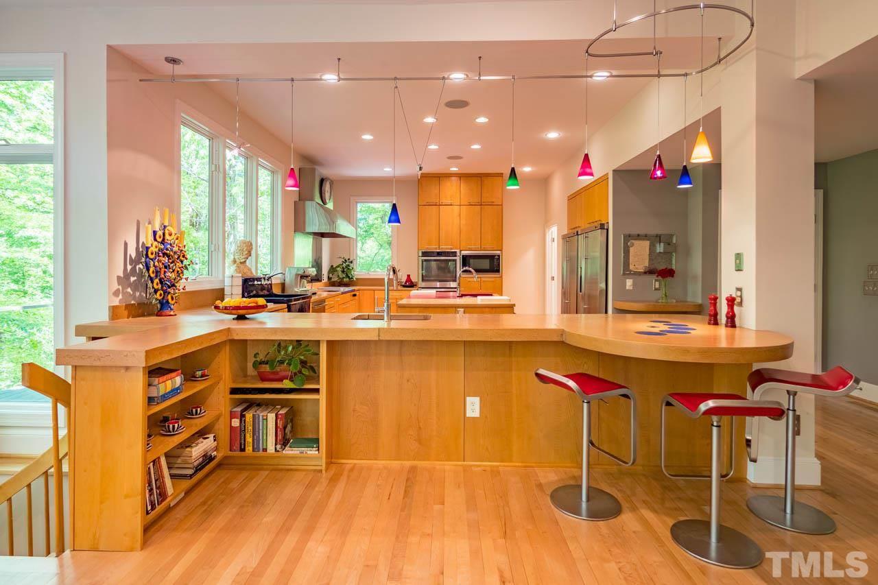 5415 Taproot Lane Durham, NC 27705 - Photo 10 of 30 a room with kitchen island granite countertop a sink and a stove