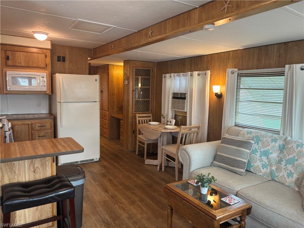 10 Jade Drive, Unit 10J Naples, FL 34114 - Photo 12 of 21 a living room with furniture and a refrigerator