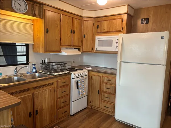 a kitchen with stainless steel appliances a refrigerator sink and cabinets