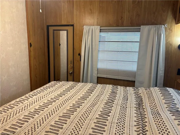 a view of a bedroom with wooden floor