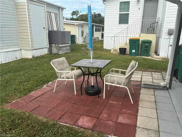 a view of a patio with table and chairs and potted plants