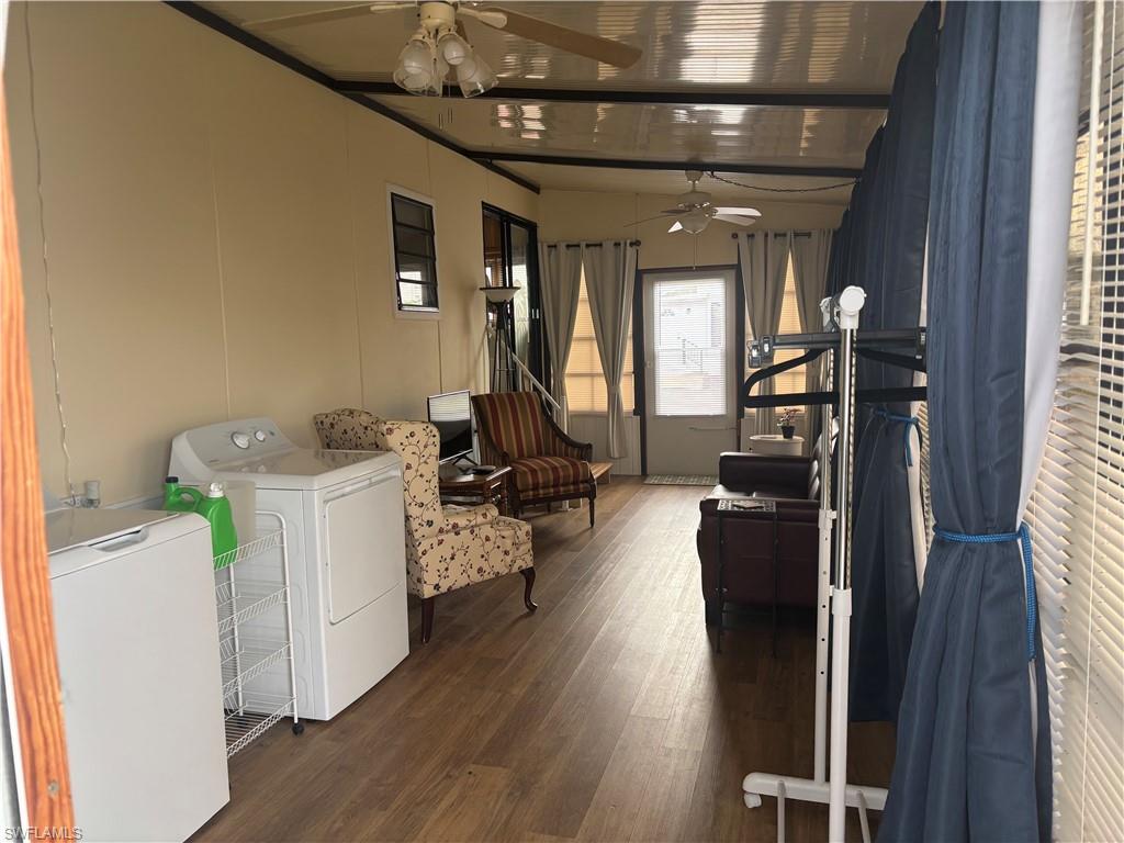 10 Jade Drive, Unit 10J Naples, FL 34114 - Photo 9 of 21 a living room with furniture and a chandelier