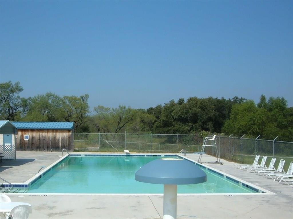 Lot 13 Dolphin Terrace Runaway Bay, TX 76426 - Photo 8 of 8 a view of swimming pool with a back yard
