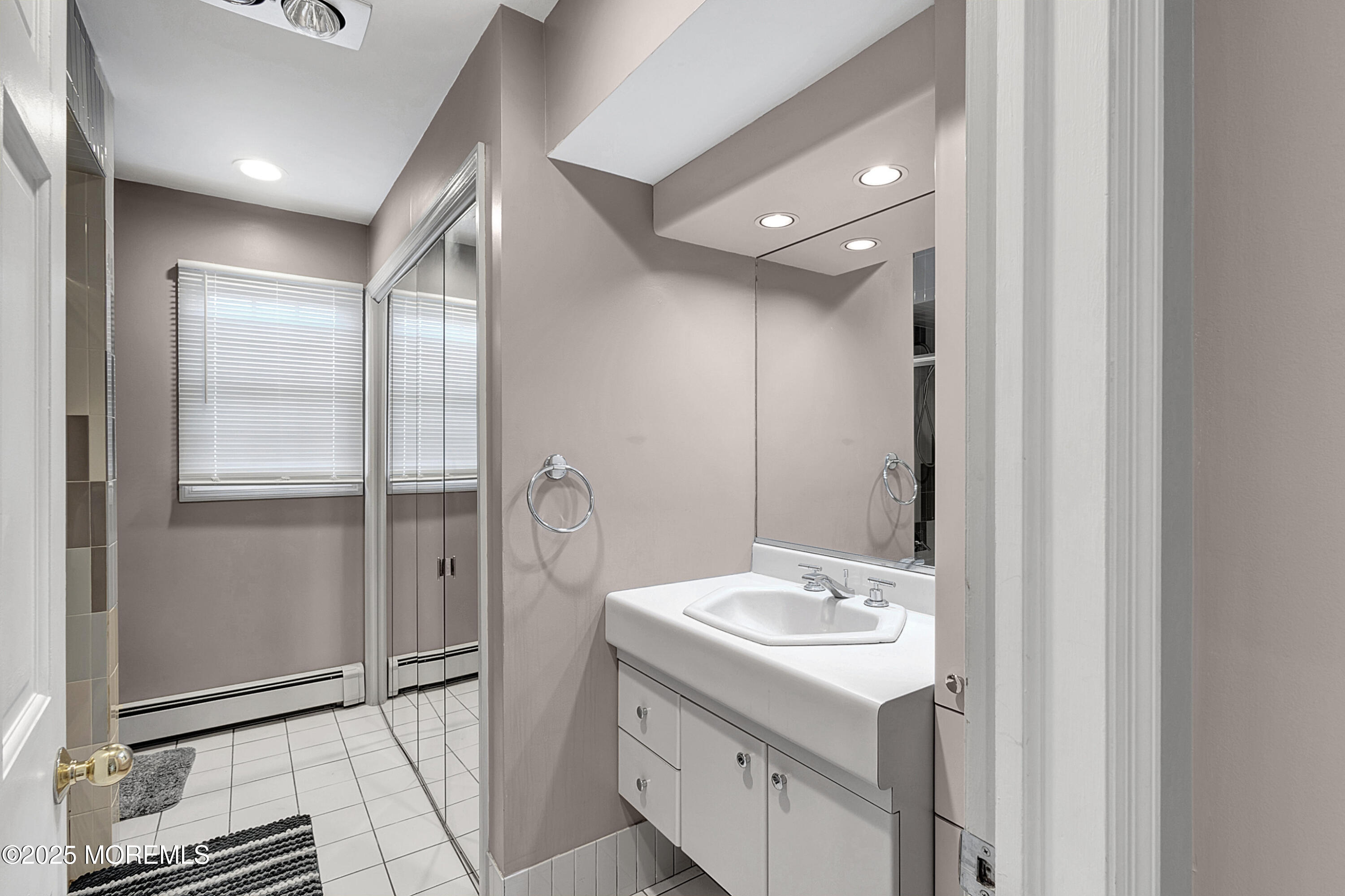 32 Kilfoyle Avenue Fords, NJ 08863 - Photo 13 of 33 a bathroom with a sink mirror and shower