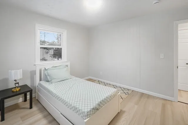 a view of a room with wooden floor
