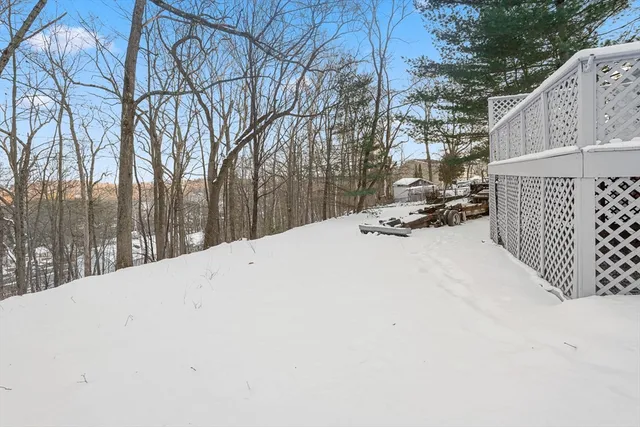 a view of white house with a yard covered in snow
