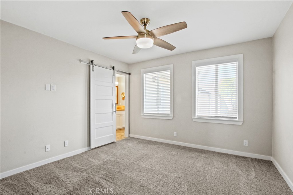 8410 Arrow Route Rancho Cucamonga, CA 91730 - Photo 11 of 24 a view of an empty room with a ceiling fan