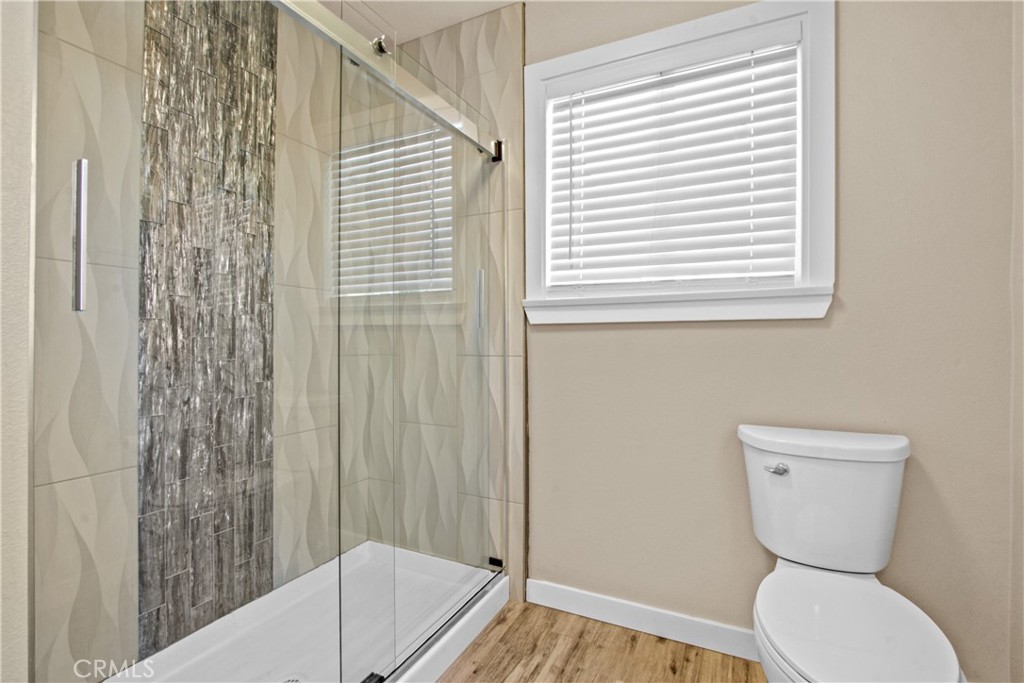 8410 Arrow Route Rancho Cucamonga, CA 91730 - Photo 14 of 24 a bathroom with a toilet and a shower