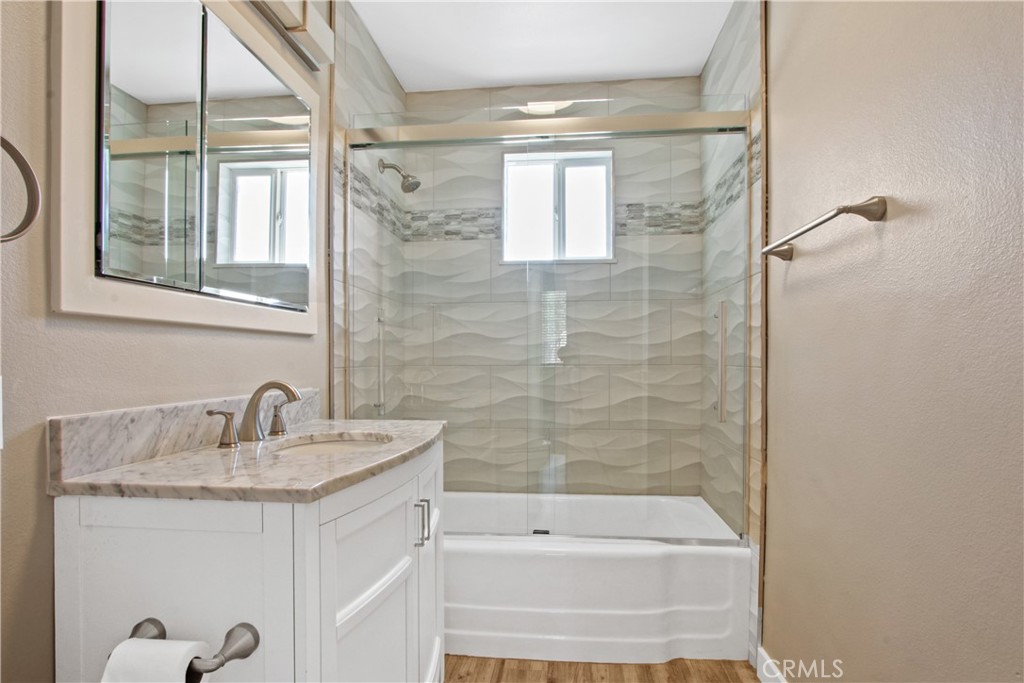 8410 Arrow Route Rancho Cucamonga, CA 91730 - Photo 17 of 24 a bathroom with a granite countertop sink a toilet and shower