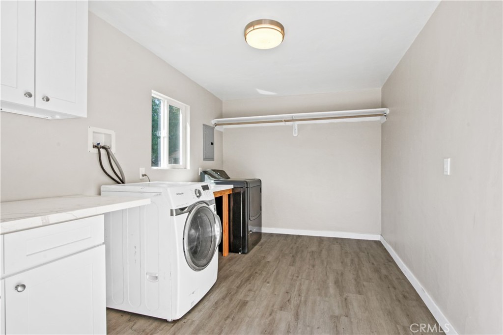 8410 Arrow Route Rancho Cucamonga, CA 91730 - Photo 24 of 24 a storage room with wooden floor washer and dryer