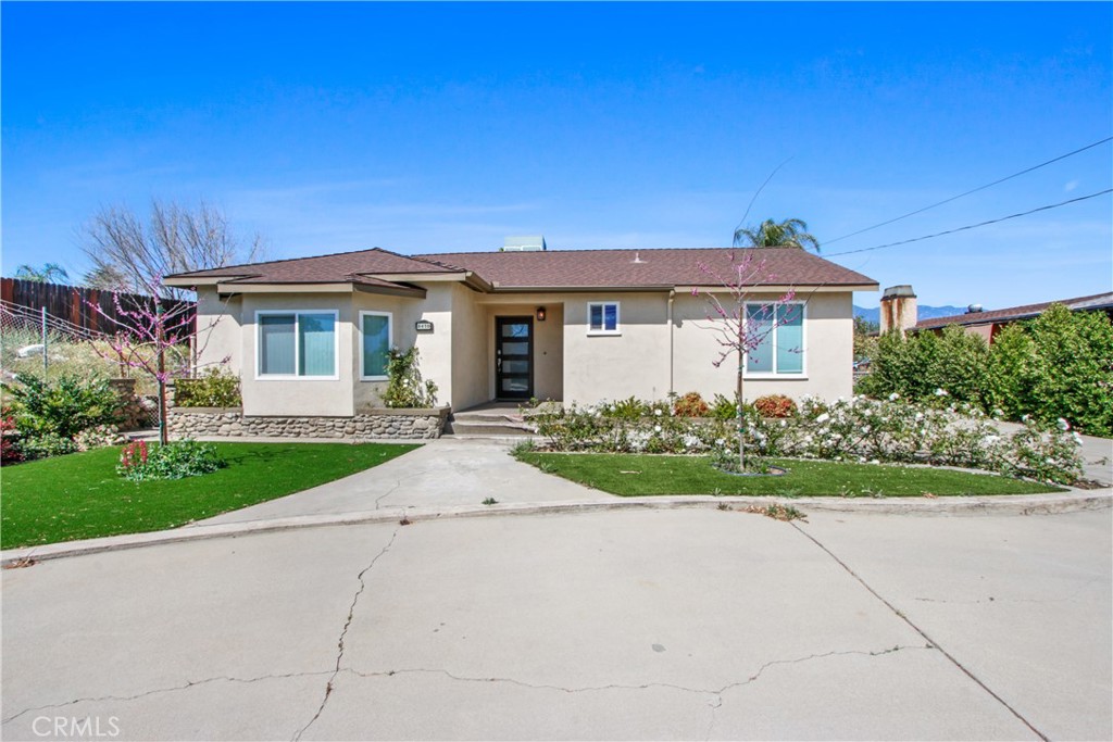 8410 Arrow Route Rancho Cucamonga, CA 91730 - Photo 3 of 24 a front view of a house with a garden