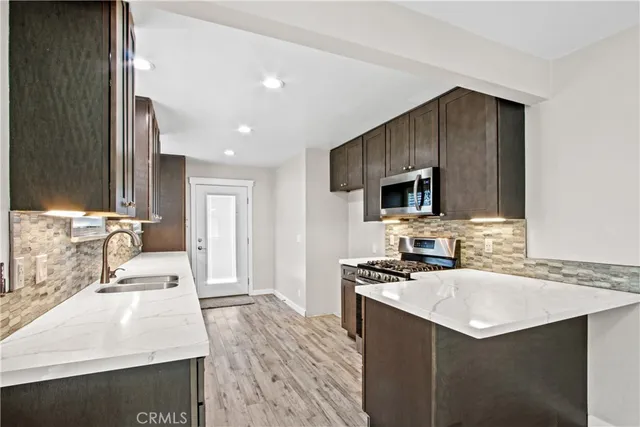 a kitchen with a sink stove and refrigerator