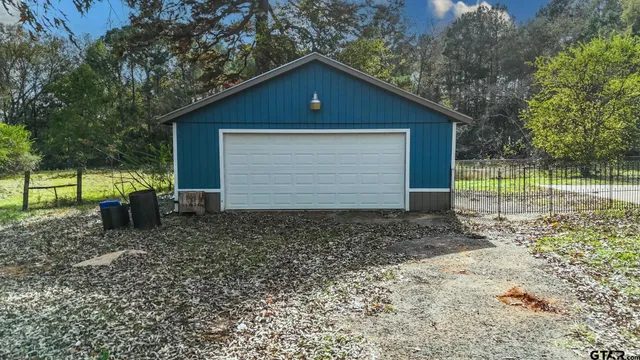a view of backyard of house with green space