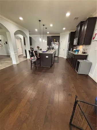 a spacious bedroom with a bed and a chandelier