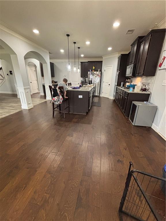 328 Vantage Point Locust Grove, GA 30248 - Photo 12 of 33 a living room with stainless steel appliances furniture and a wooden floor