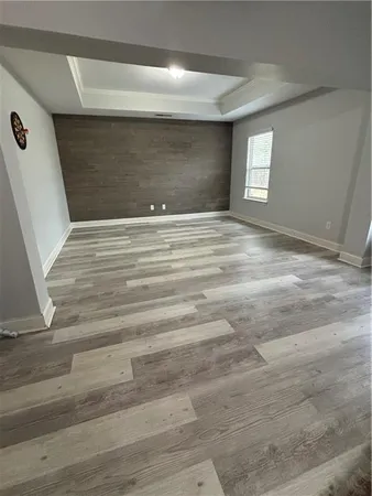 a bedroom with a bed dresser and a window