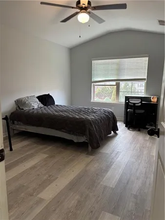a bedroom with a bed and glass door
