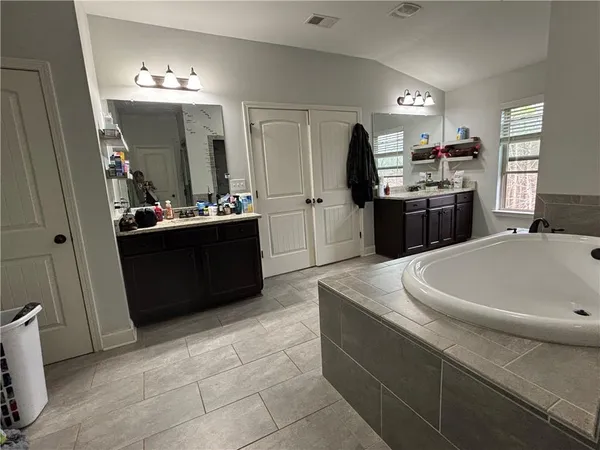 a kitchen with a sink a counter space cabinets and appliances