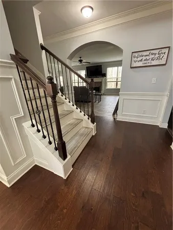 a view of entryway and hall with wooden floor