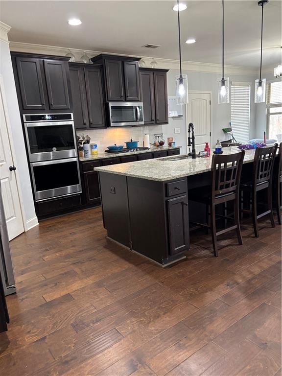 328 Vantage Point Locust Grove, GA 30248 - Photo 10 of 33 a kitchen with wooden cabinets a sink and a stove