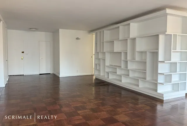a view of a room with wooden floors and window