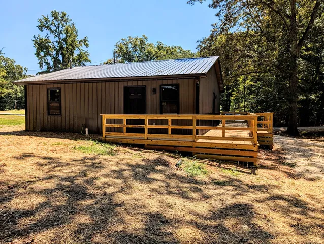 a view of a house with a large window and a yard