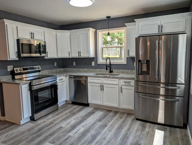 a kitchen with a refrigerator stove and microwave