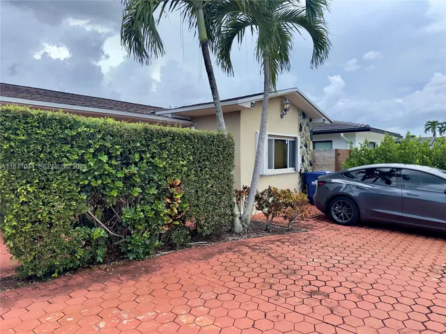 a view of a swimming pool with a garden and plants