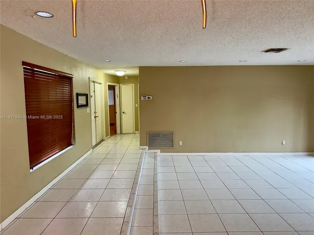 a bathroom with a granite countertop shower and a toilet