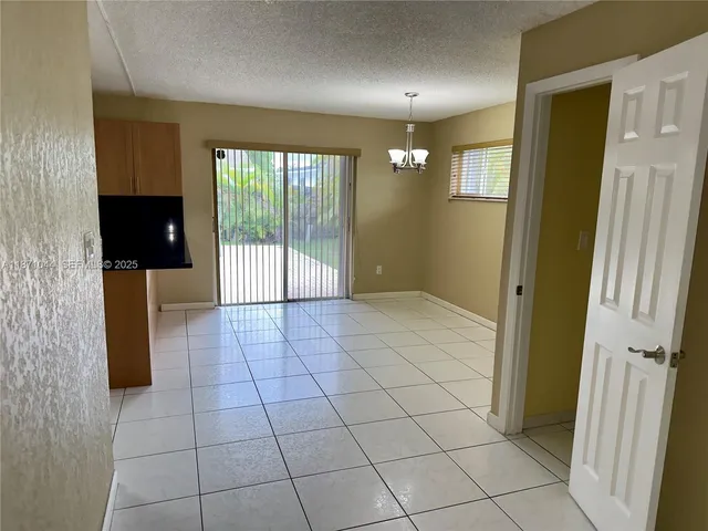 a view of a room that has a fan and a table in it