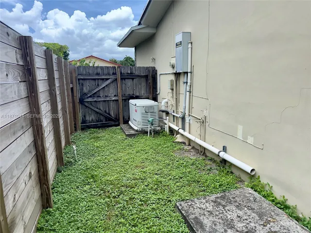 an aerial view of a house with a swimming pool and garden