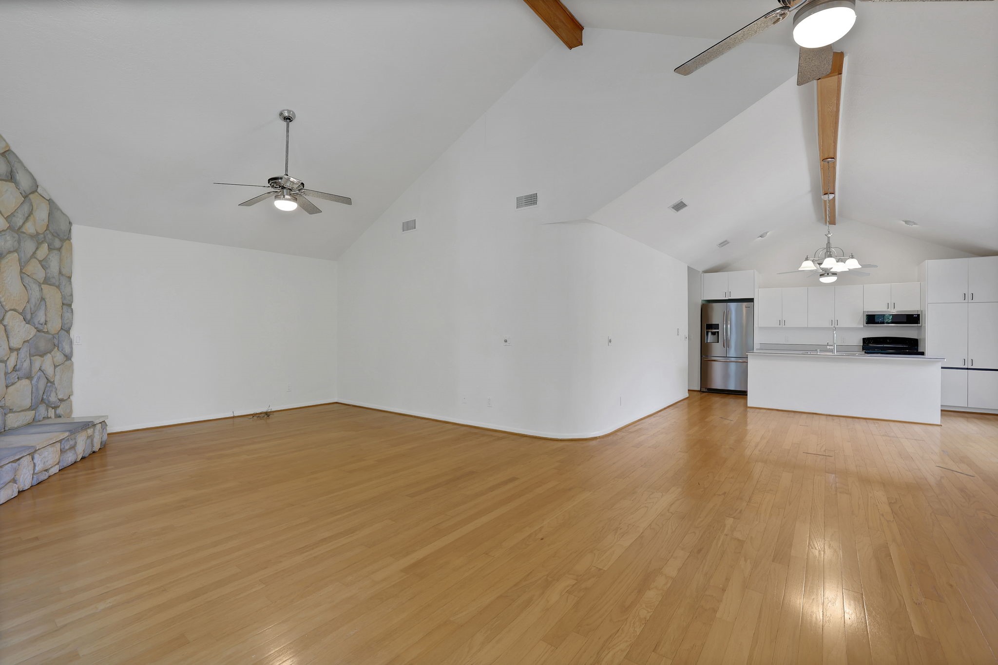 200 Johnson Road Coldspring, TX 77331 - Photo 16 of 47 The high ceilings with wood beam accent extend through to the dining area and kitchen