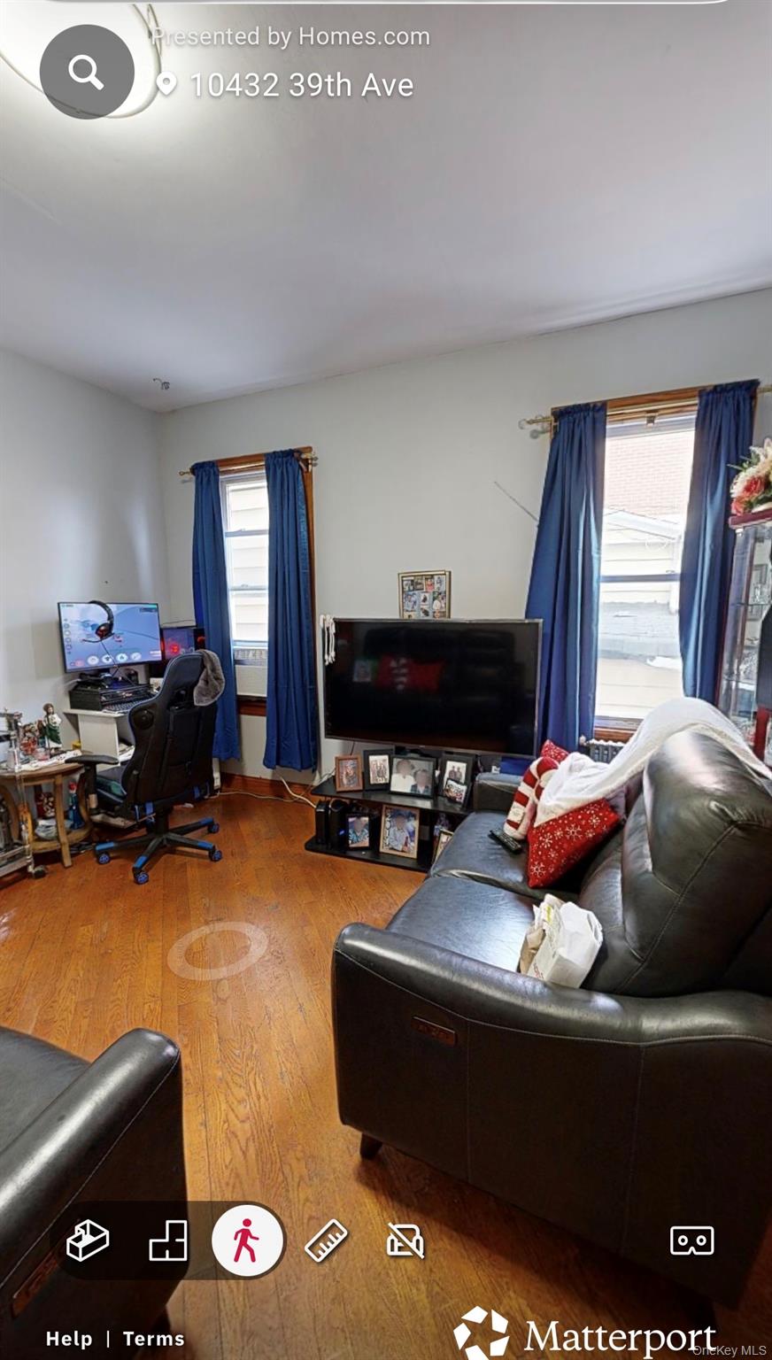 104-32 39th Avenue Queens, NY 11368 - Photo 11 of 11 a living room with furniture and a fireplace