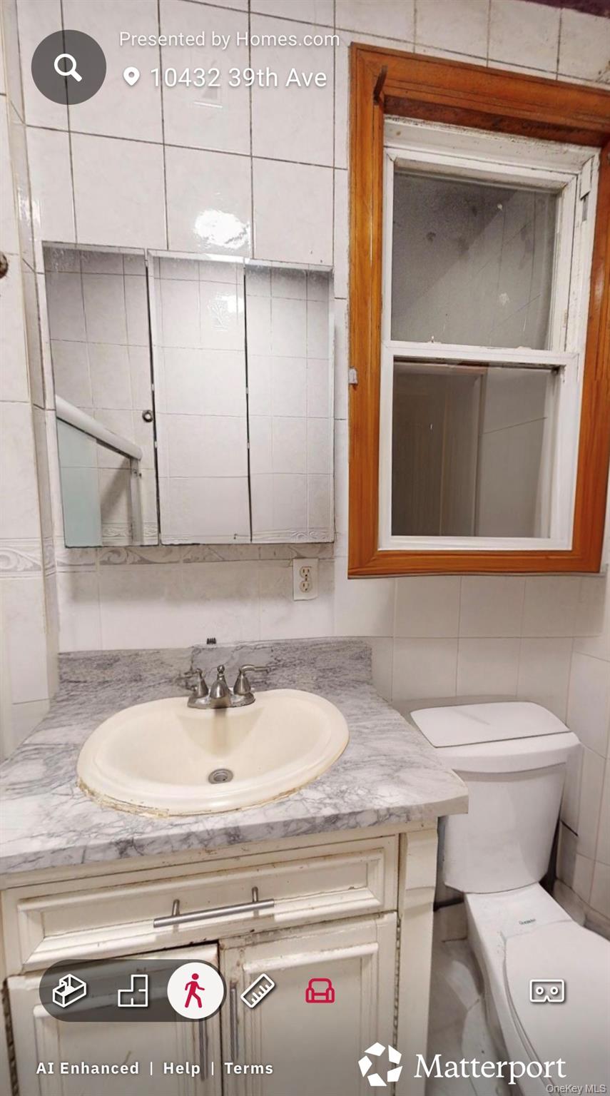 104-32 39th Avenue Queens, NY 11368 - Photo 5 of 11 a bathroom with a sink and a toilet