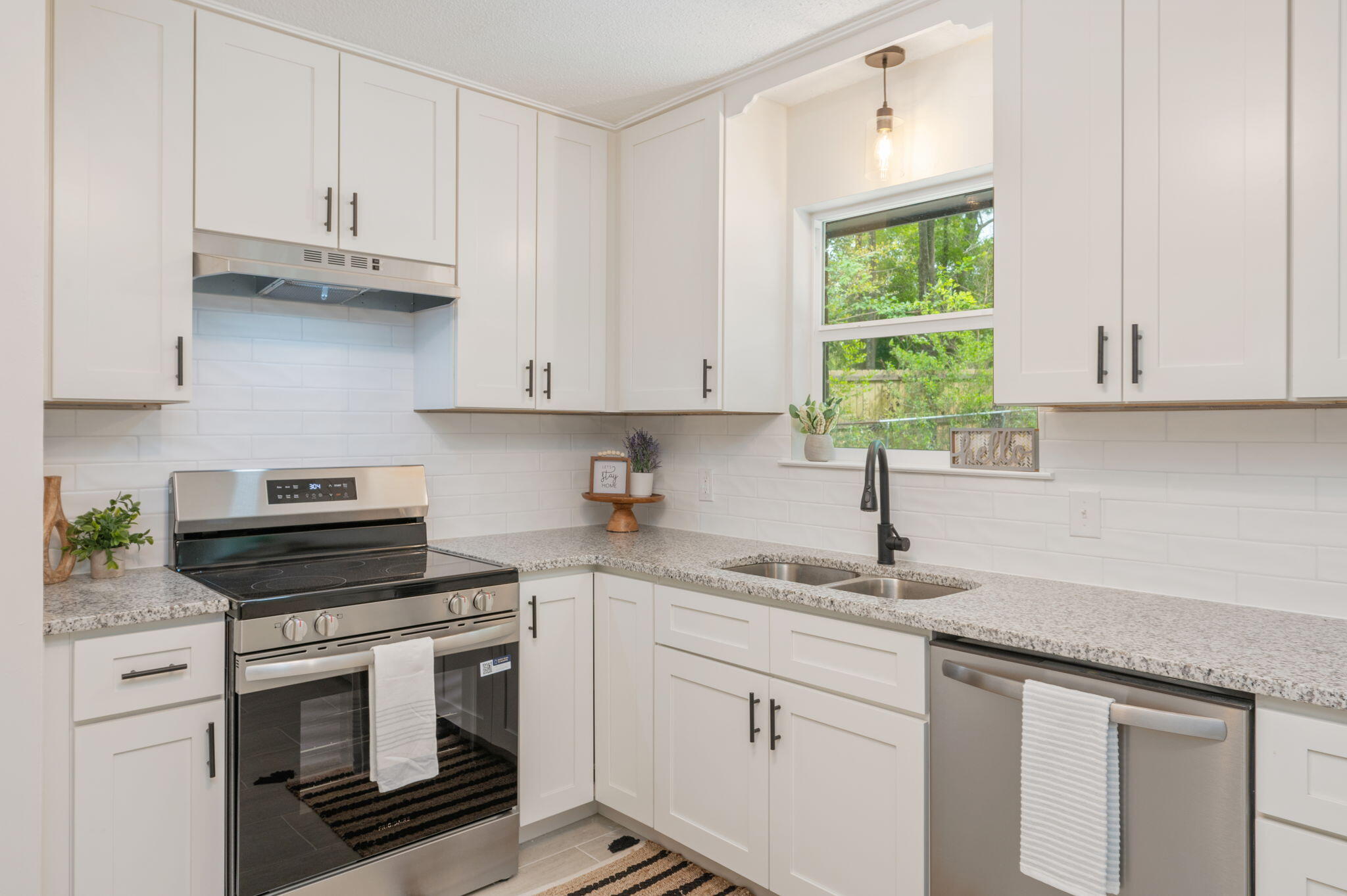 128 Salvadore Drive Crestview, FL 32536 - Photo 11 of 30 a kitchen with granite countertop white cabinets white appliances and a sink