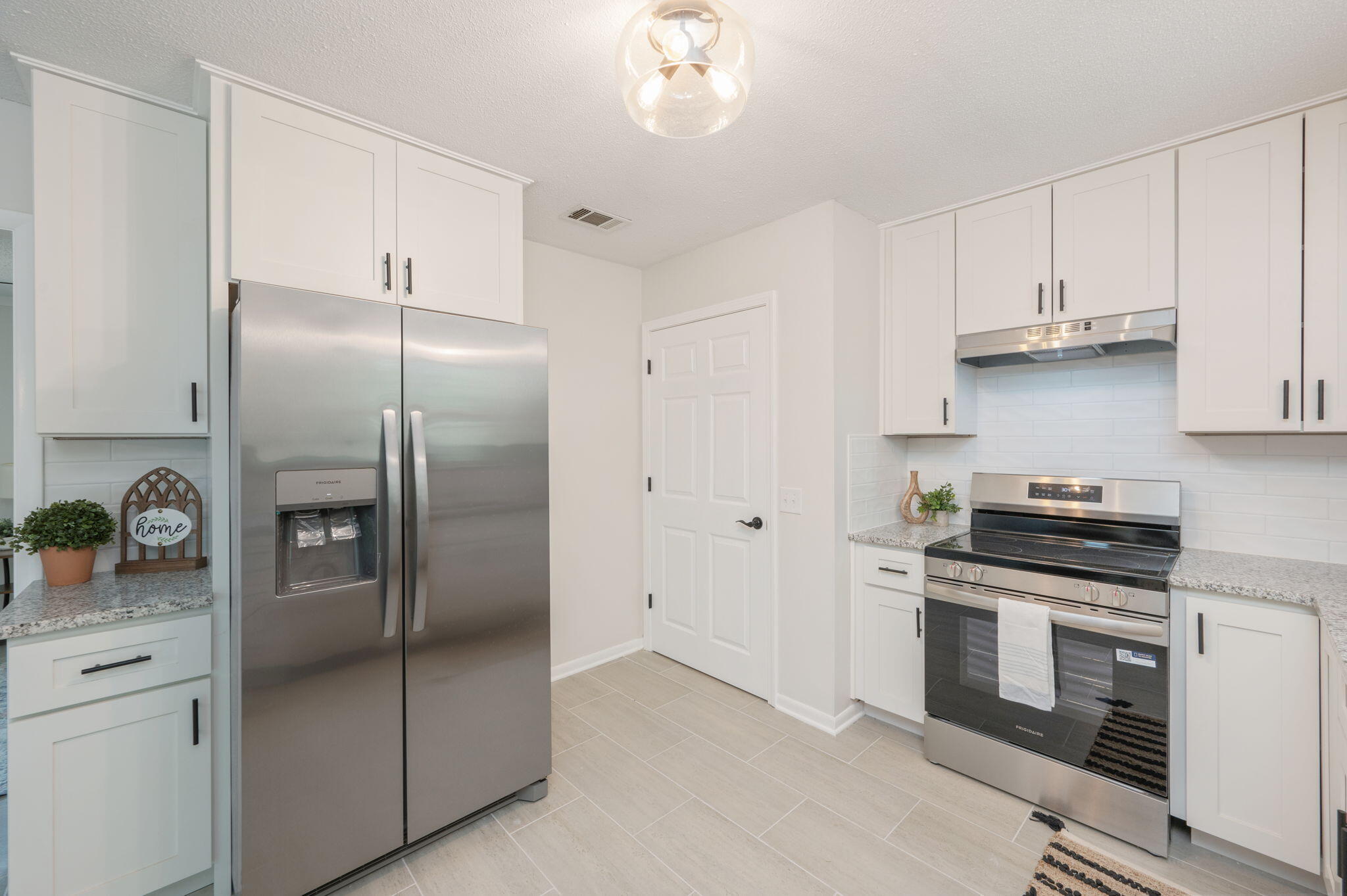 128 Salvadore Drive Crestview, FL 32536 - Photo 12 of 30 a kitchen with stainless steel appliances granite countertop a refrigerator a stove a sink and dishwasher