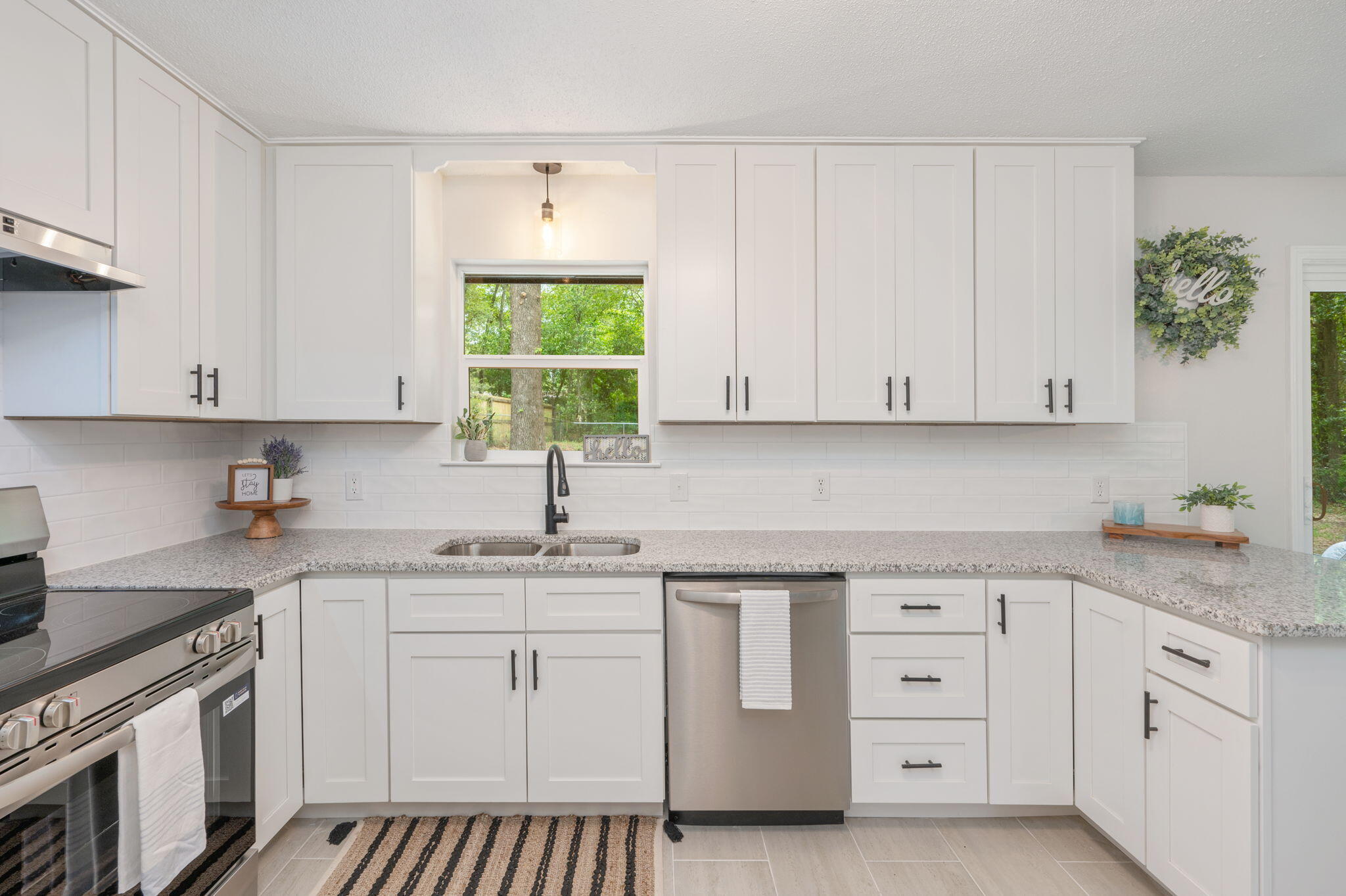 128 Salvadore Drive Crestview, FL 32536 - Photo 13 of 30 a kitchen with white cabinets appliances and a window