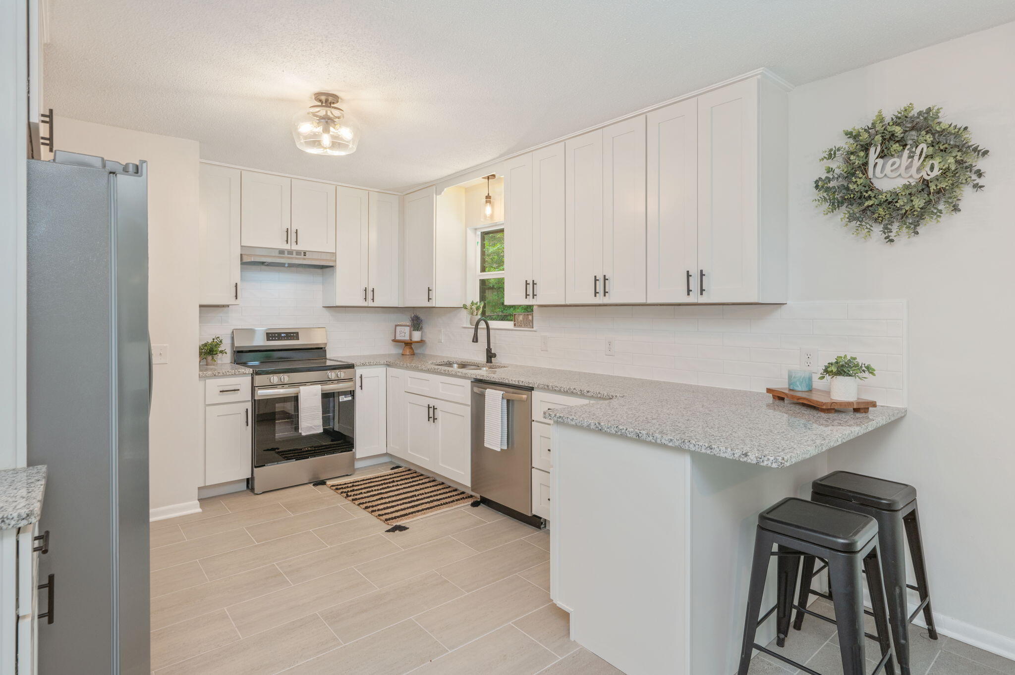 128 Salvadore Drive Crestview, FL 32536 - Photo 10 of 30 a kitchen with granite countertop white cabinets and white appliances