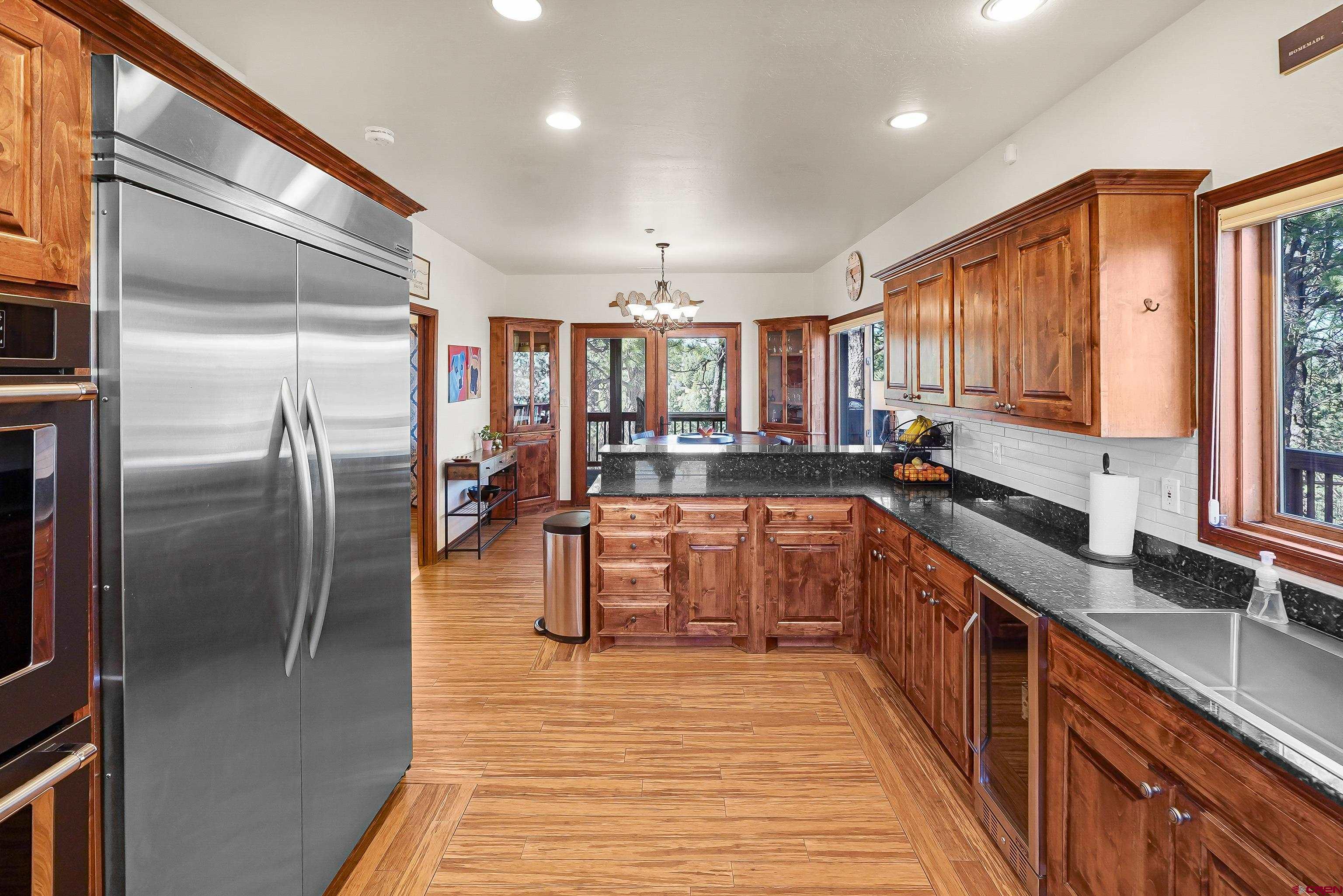287 Wildcat Road Hesperus, CO 81326 - Photo 12 of 44 a kitchen with stainless steel appliances granite countertop a refrigerator a sink a stove and cabinets