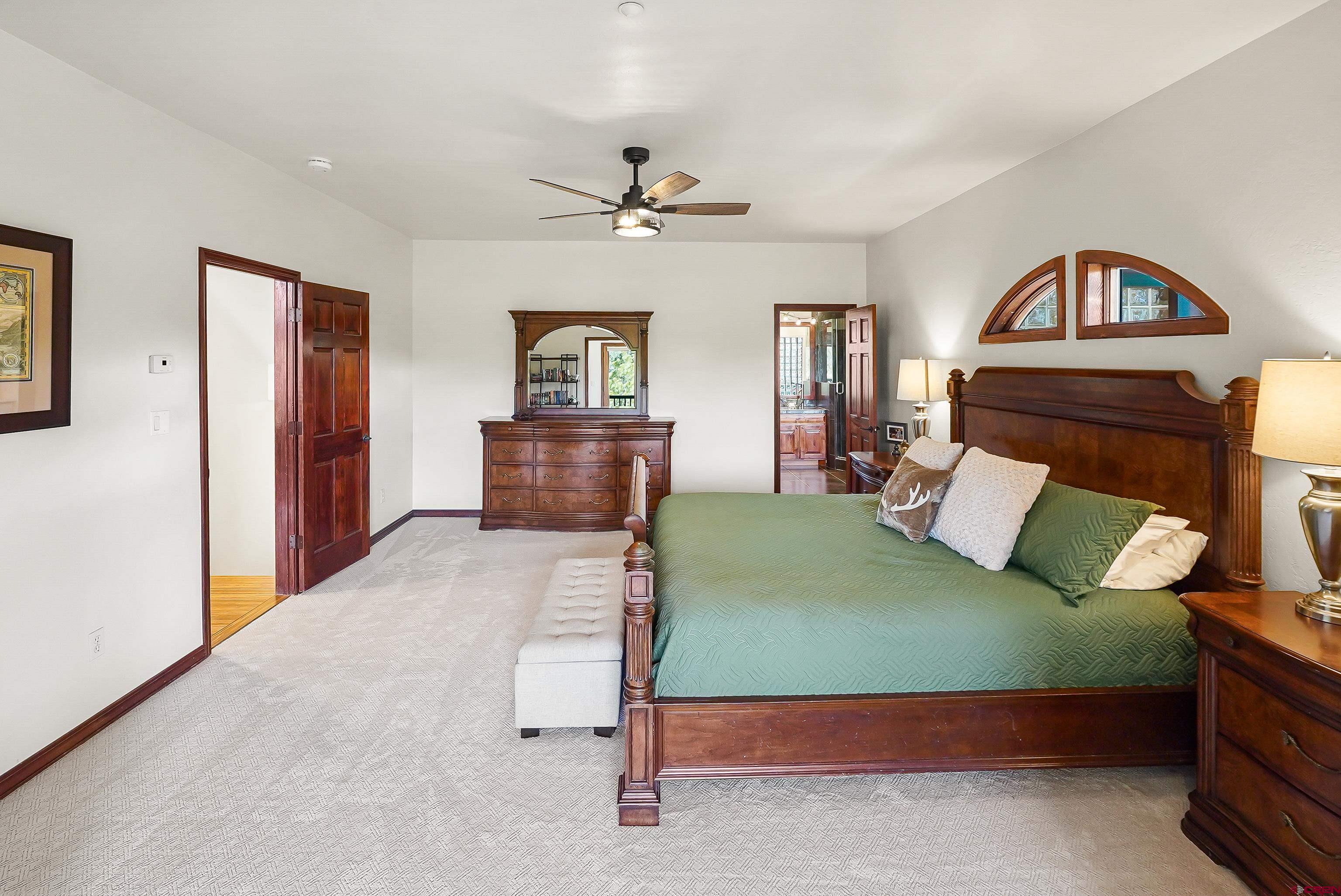 287 Wildcat Road Hesperus, CO 81326 - Photo 14 of 44 a bedroom with a bed and a chandelier