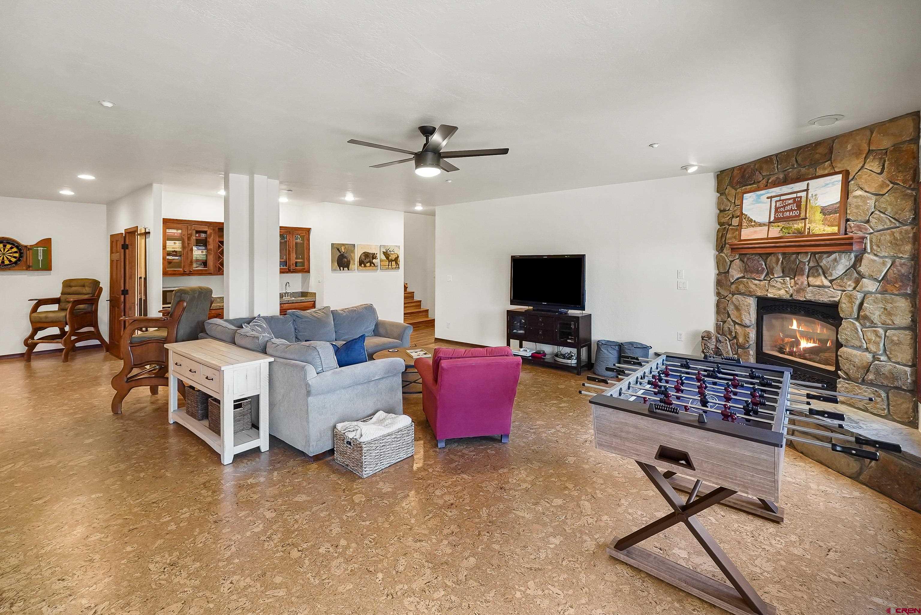 287 Wildcat Road Hesperus, CO 81326 - Photo 28 of 44 a living room with furniture gym equipment and a fireplace