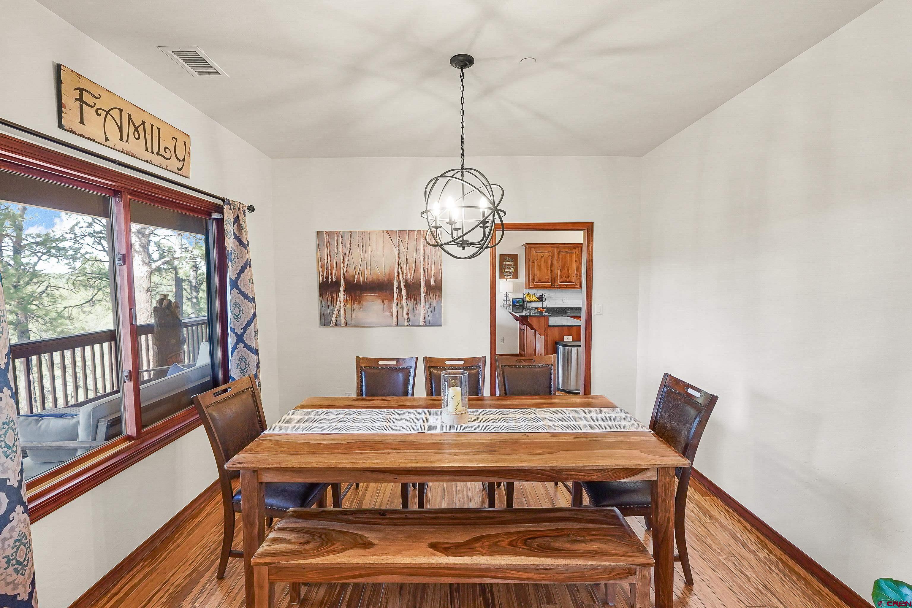 287 Wildcat Road Hesperus, CO 81326 - Photo 9 of 44 a view of a dining room with furniture wooden floor and a chandelier