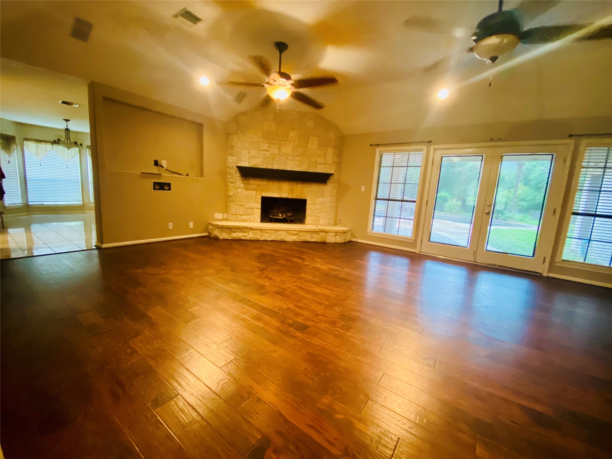14212 Horseshoe Bend Conroe, TX 77384 - Photo 16 of 45 an empty room with wooden floor and a fireplace