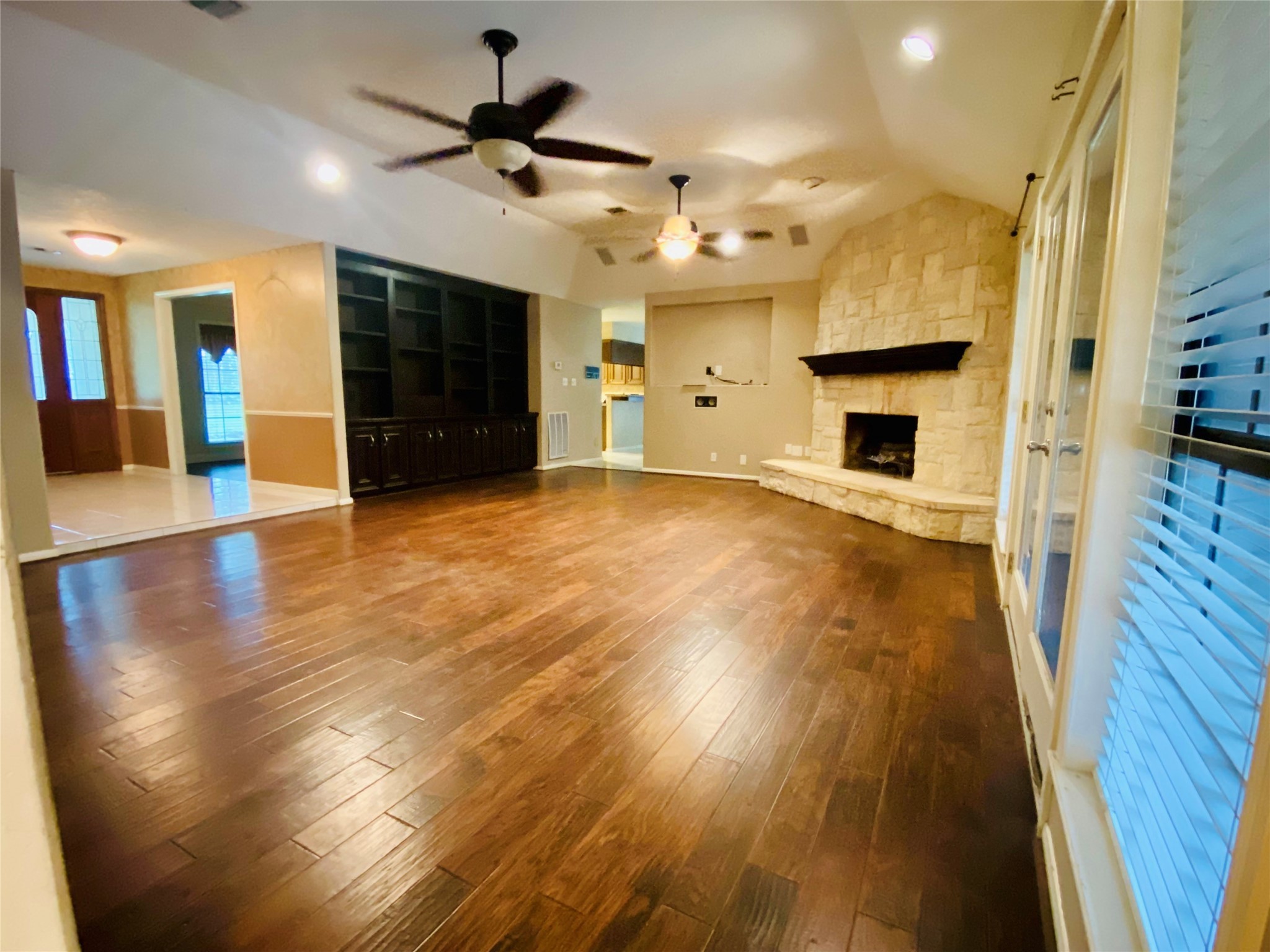 14212 Horseshoe Bend Conroe, TX 77384 - Photo 22 of 45 a view of empty room with wooden floor and a fireplace