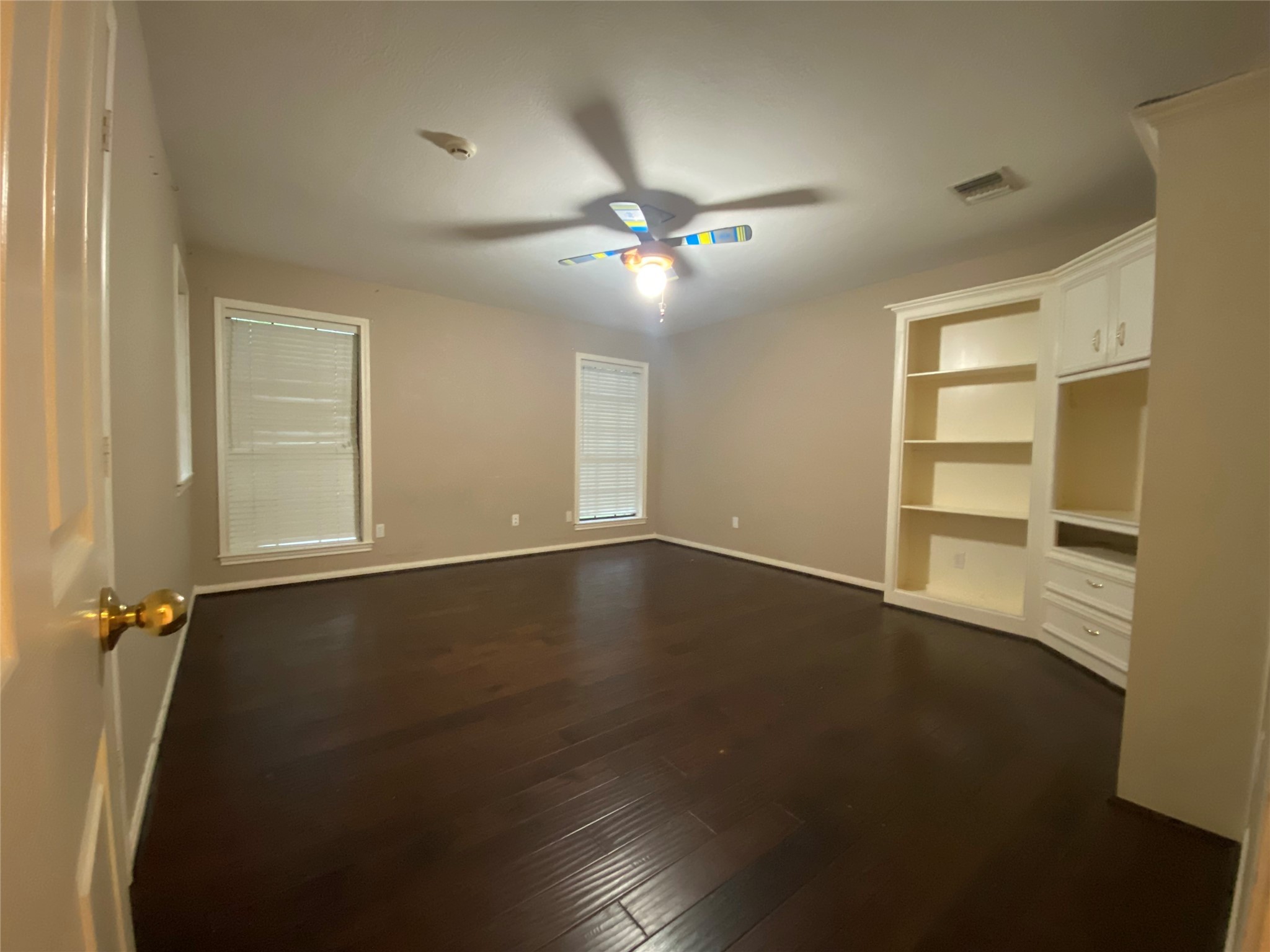 14212 Horseshoe Bend Conroe, TX 77384 - Photo 30 of 45 an empty room with wooden floor fan and windows