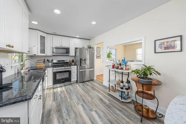 a kitchen with granite countertop stainless steel appliances a sink and counter space