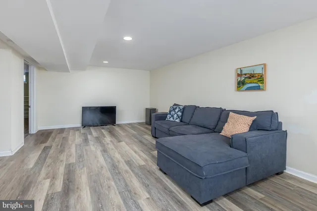 a living room with a couch and a potted plant
