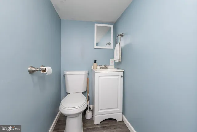 a white toilet sitting next to a white sink