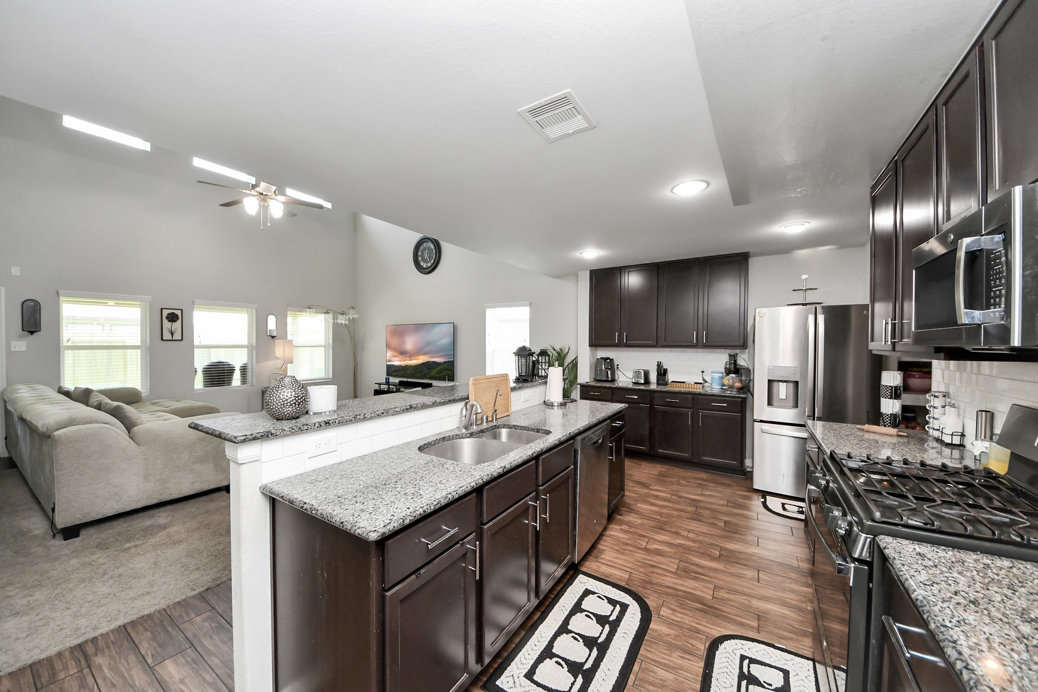 2643 Ridgeback Drive Rosenberg, TX 77471 - Photo 13 of 46 a large kitchen with granite countertop lots of counter top space a sink and stainless steel appliances